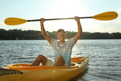 Photo of Happy man kayaking on river. Summer activity