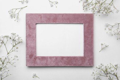 Frame and beautiful gypsophila flowers on white background, flat lay. Space for text