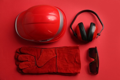 Photo of Flat lay composition with safety equipment on color background
