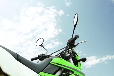 Photo of Green stylish cross motorcycle outdoors, low angle view