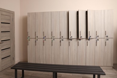 Wooden bench and lockers in changing room interior