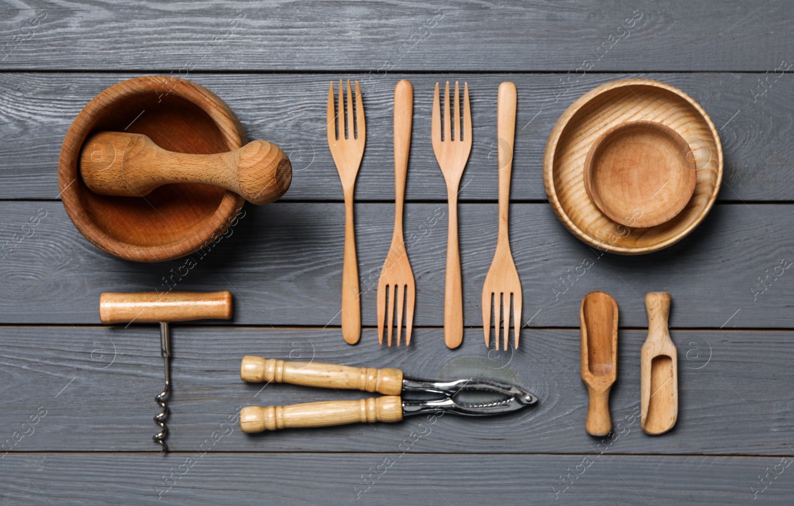 Photo of Set of modern cooking utensils on wooden table, flat lay