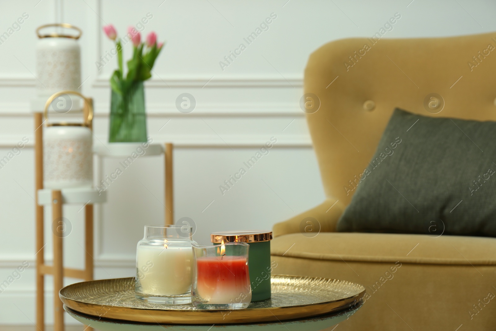 Photo of Burning candles in glass holders on table indoors, space for text. Interior elements