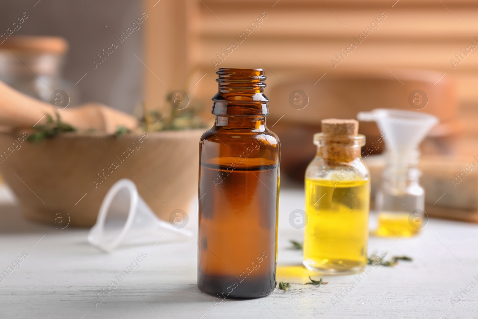 Photo of Bottles with essential oils on wooden table