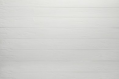 Photo of Texture of white wooden board on black background, top view