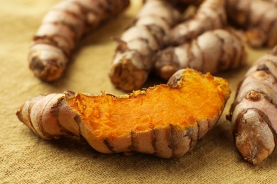 Photo of Many raw turmeric roots on table, closeup