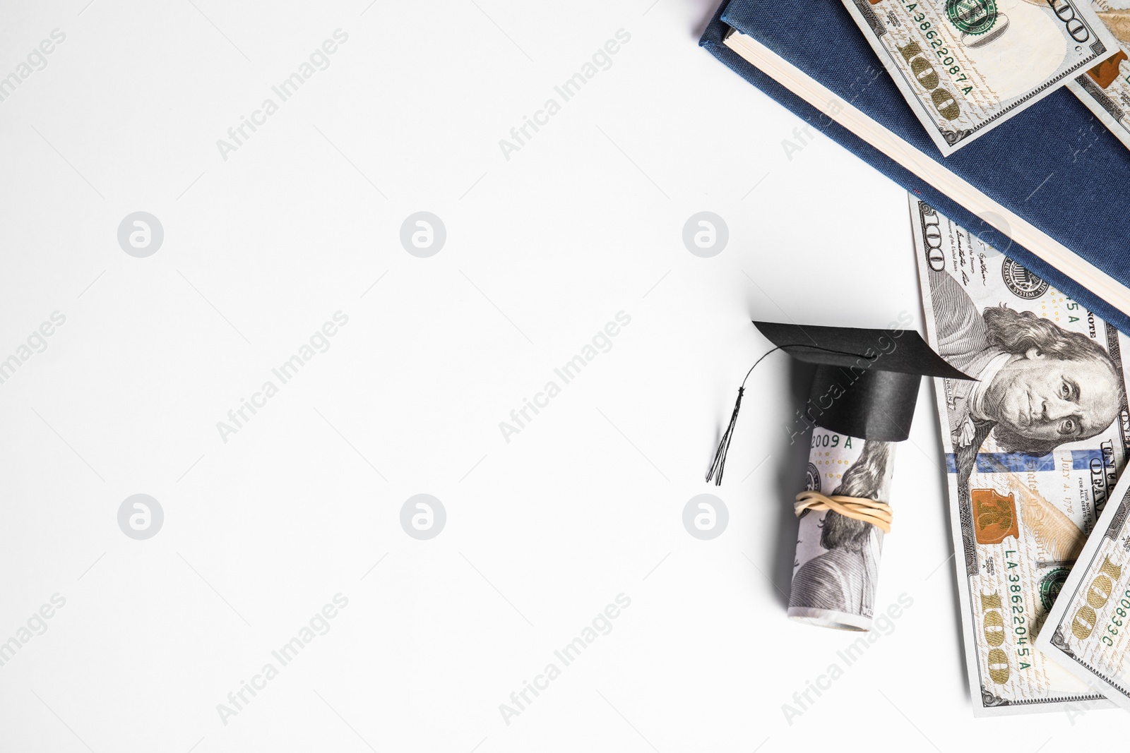 Photo of Flat lay composition with dollar banknotes and student graduation hat on white background, space for text. Tuition fees concept