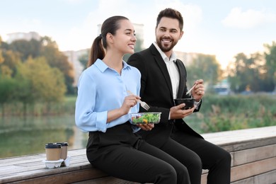 Smiling business people spending time together during lunch outdoors