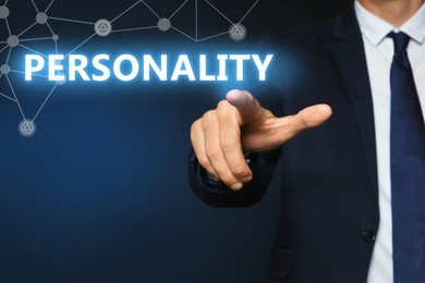 Image of Man pointing at word PERSONALITY on virtual screen against dark blue background, closeup 