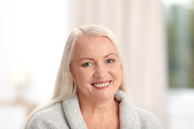 Portrait of beautiful older woman against blurred background