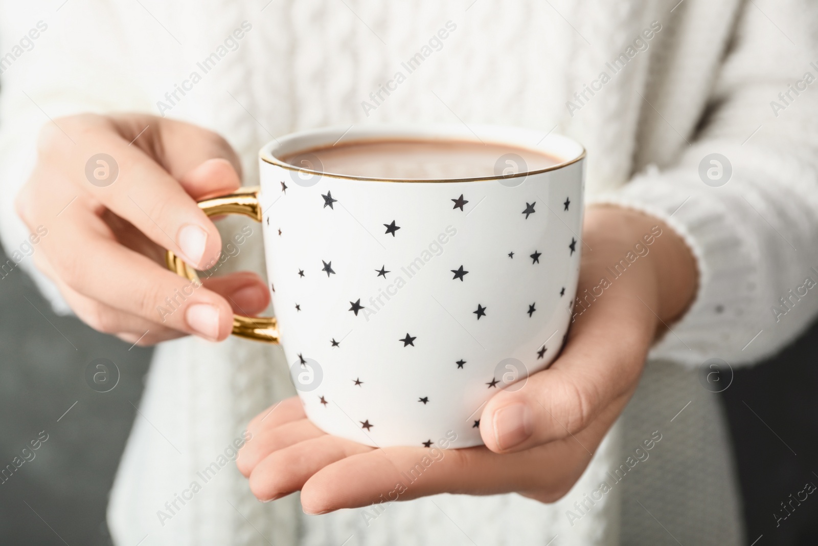 Photo of Woman holding cup of tasty cocoa, closeup