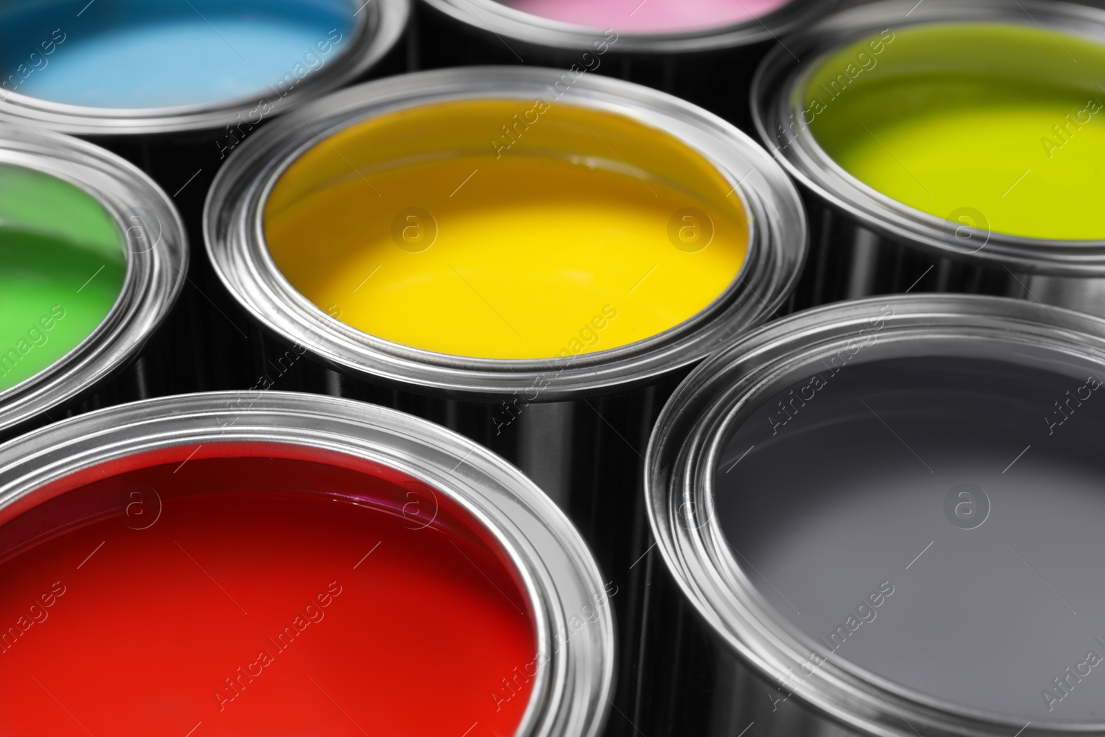 Photo of Open cans of different paints as background, closeup