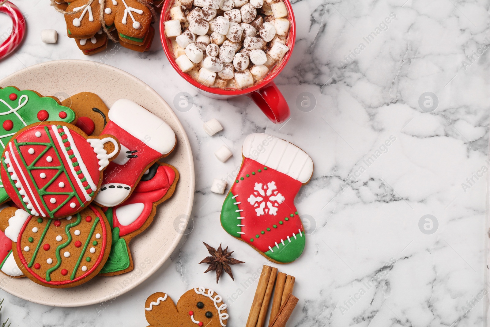 Photo of Flat lay composition with decorated Christmas cookies on white marble table. Space for text