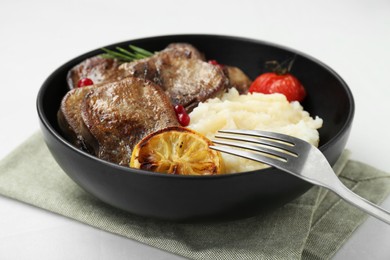 Photo of Tasty beef tongue pieces, berries, lemon, rosemary, tomato and mashed potatoes on white table, closeup