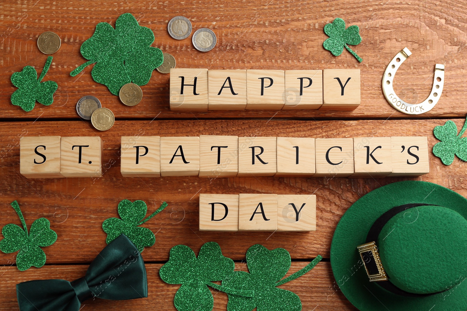 Photo of Words Happy St. Patrick's day and festive decor on wooden background, flat lay