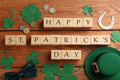 Words Happy St. Patrick's day and festive decor on wooden background, flat lay