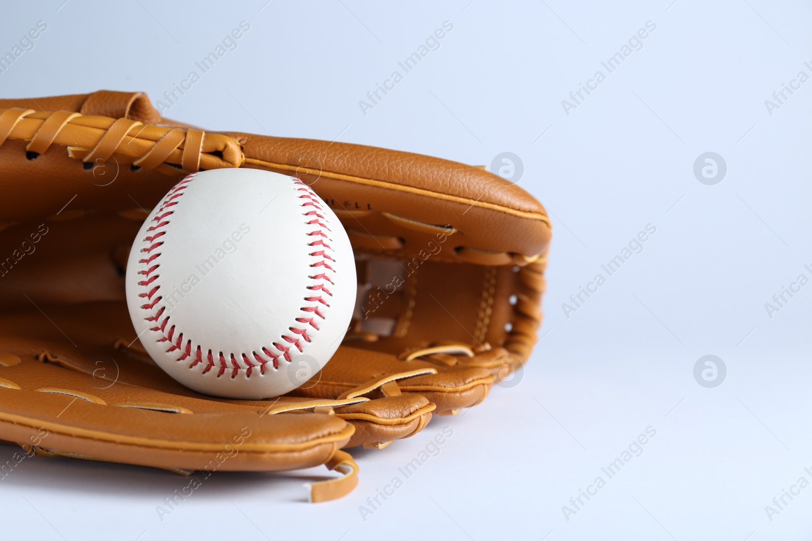 Photo of Catcher's mitt and baseball ball on white background, space for text. Sports game