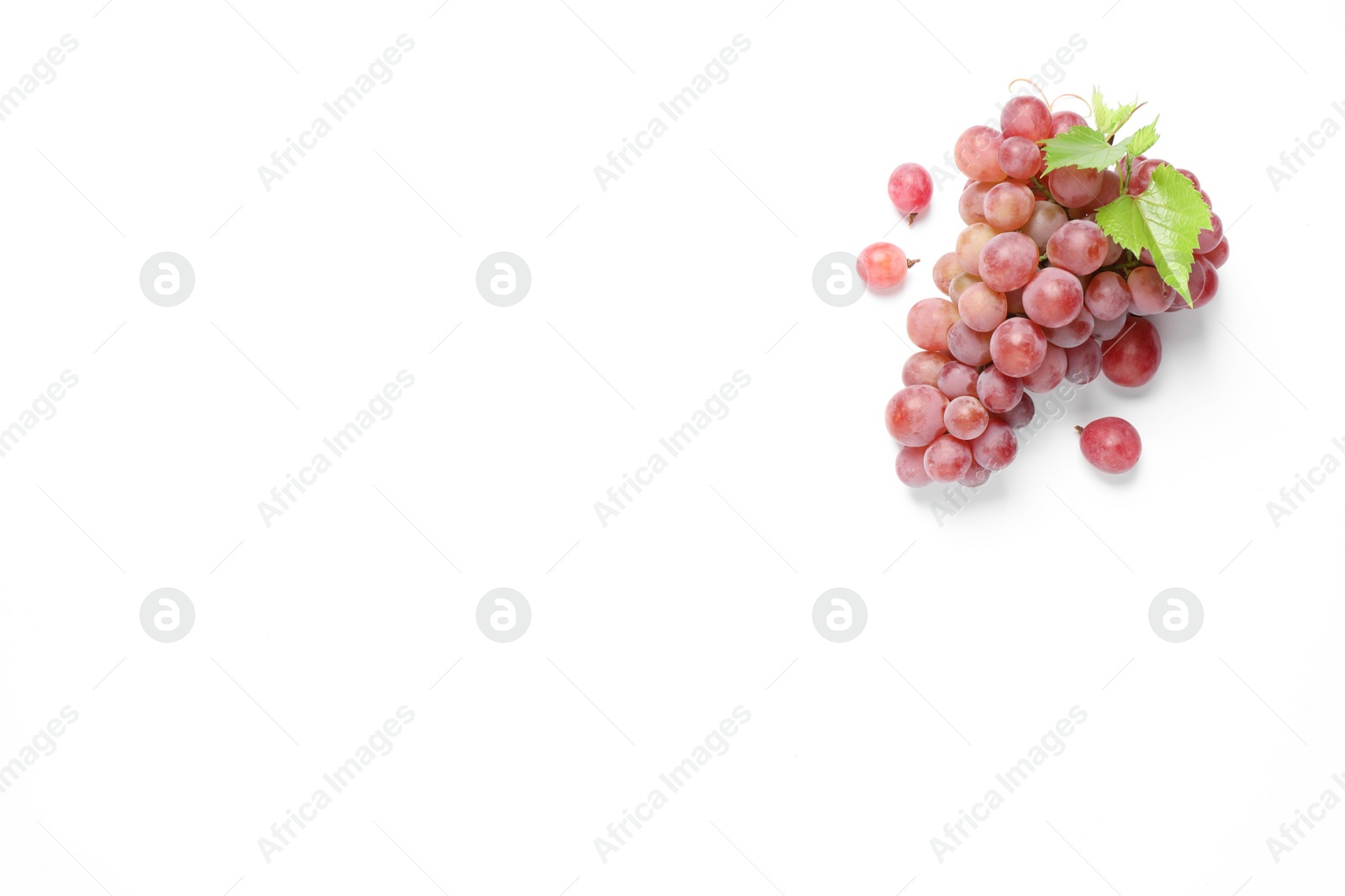 Photo of Bunch of ripe red grapes with green leaves on white background, top view
