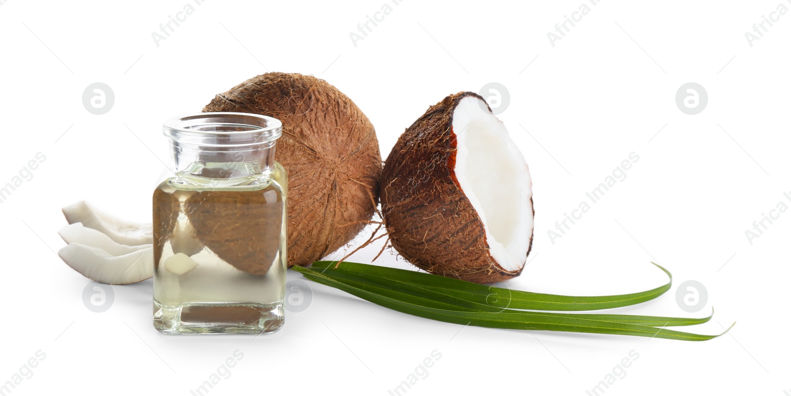 Photo of Ripe coconuts and jar with natural organic oil on white background