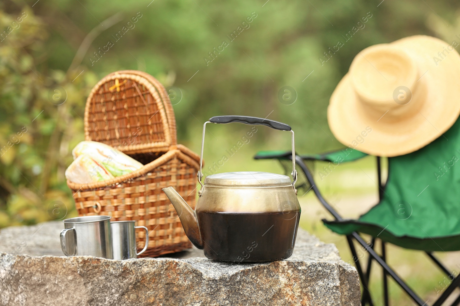 Photo of Set of camping equipment on rock outdoors