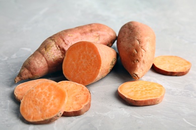 Photo of Composition with sweet potatoes on grey background