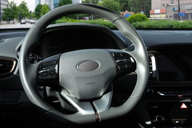 Image of Steering wheel and dashboard in modern car