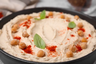 Photo of Delicious hummus with chickpeas and paprika, closeup