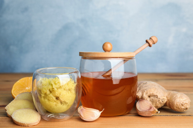 Photo of Fresh garlic and other natural cold remedies on wooden table