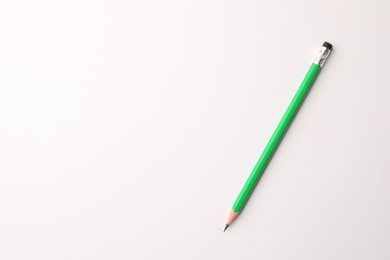 Photo of Sharp graphite pencil with eraser on white background, top view. Space for text