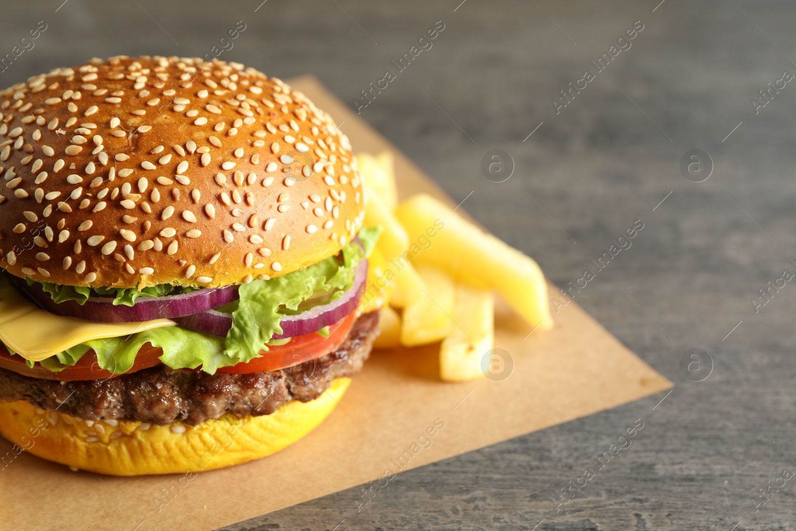 Burger with delicious patty and french fries on table, closeup Photo of Burger with delicious patty and french fries on table, closeup