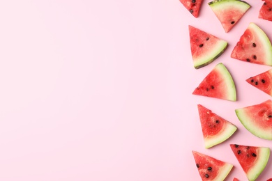 Photo of Slices of ripe watermelon on color background, top view with space for text