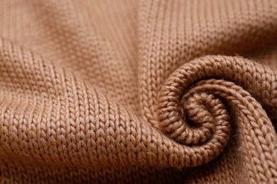Photo of Brown knitted fabric as background, closeup view