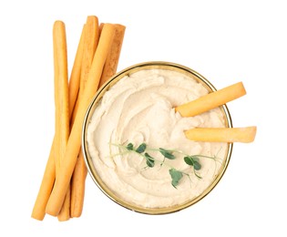 Photo of Delicious hummus with grissini sticks isolated on white, top view