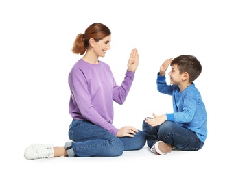 Photo of Hearing impaired mother and her child talking with help of sign language on white background