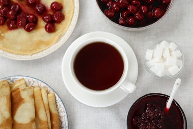 Cup of hot drink and snacks on table, flat lay. Traditional Russian tea ceremony