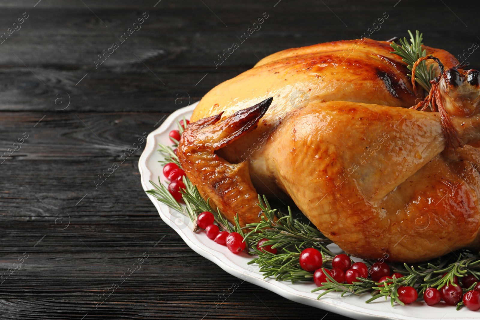 Photo of Platter of cooked turkey with garnish on table, closeup. Space for text