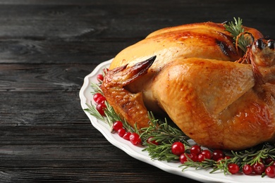 Platter of cooked turkey with garnish on table, closeup. Space for text