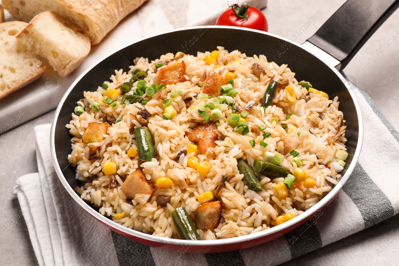 Photo of Delicious rice pilaf with vegetables on table
