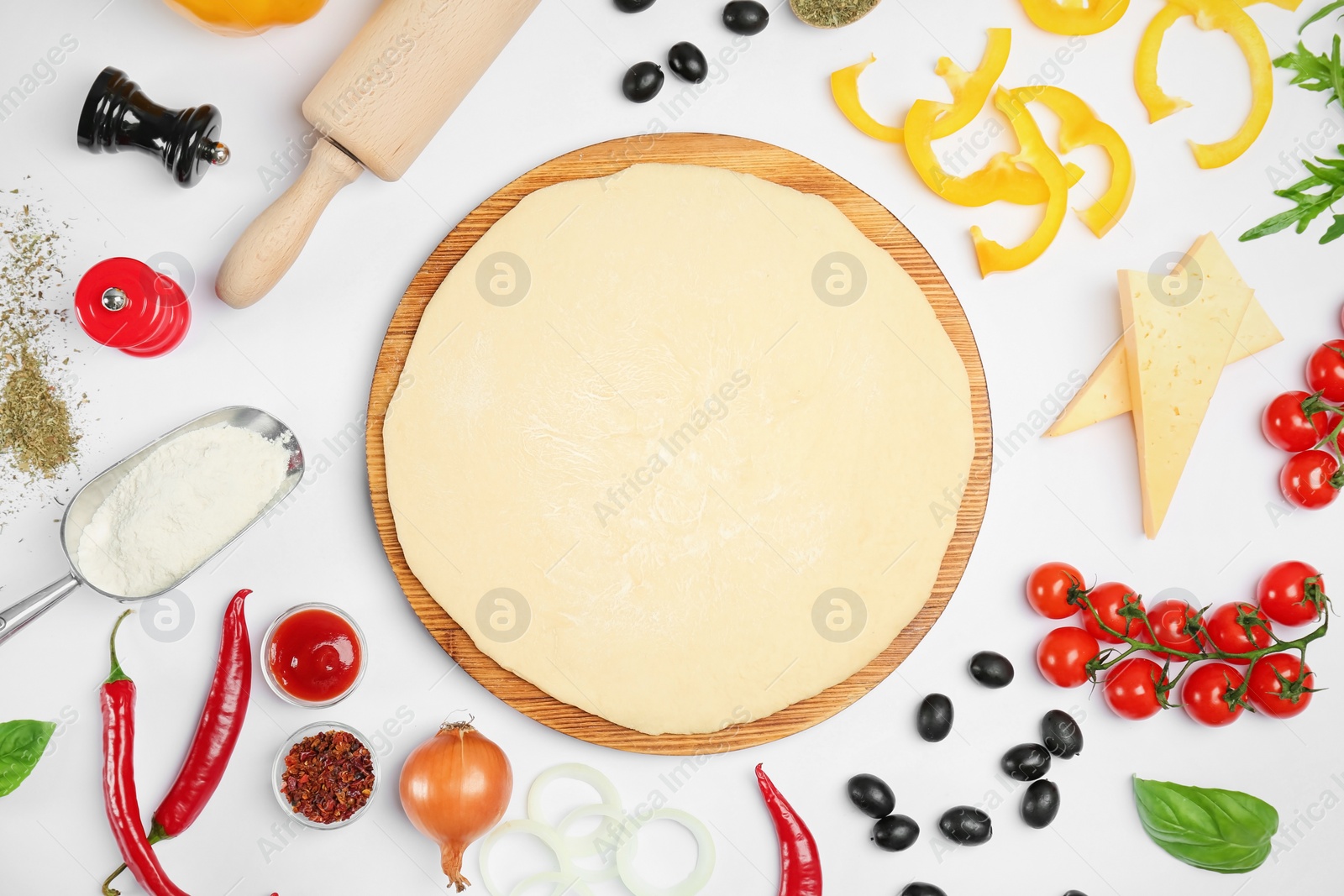 Photo of Dough and ingredients for pizza on white background, top view