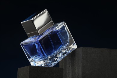 Luxury men`s perfume in bottle against dark background