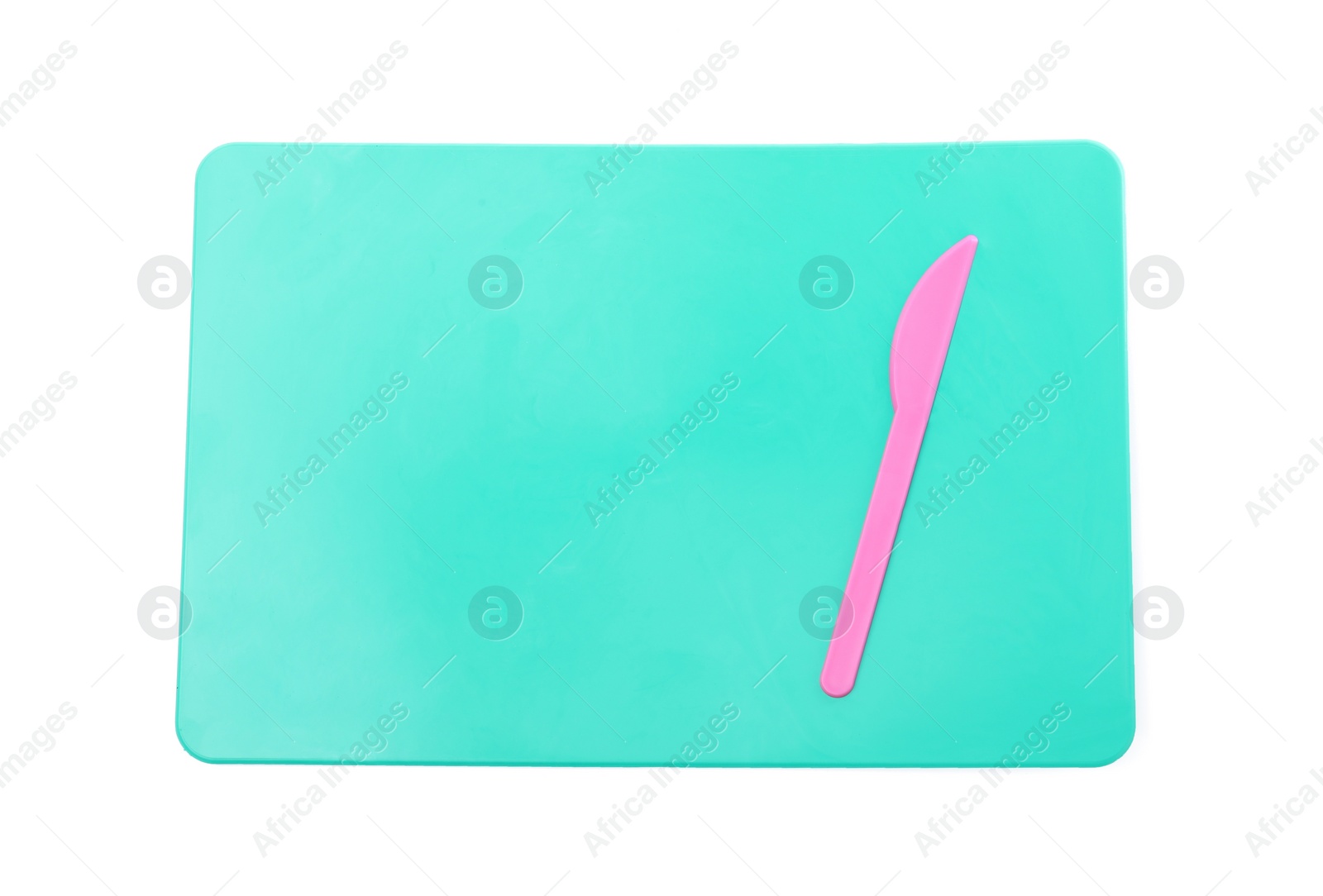 Photo of Turquoise board with knife for plasticine on white background, top view