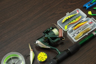 Photo of Fishing tackle on dark wooden background, space for text