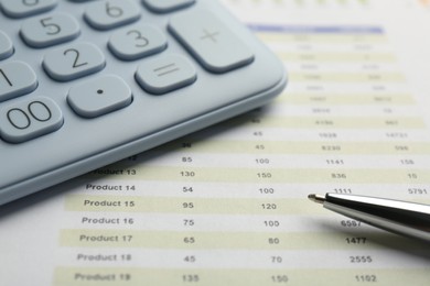 Photo of Calculator and pen on accounting document with data, closeup