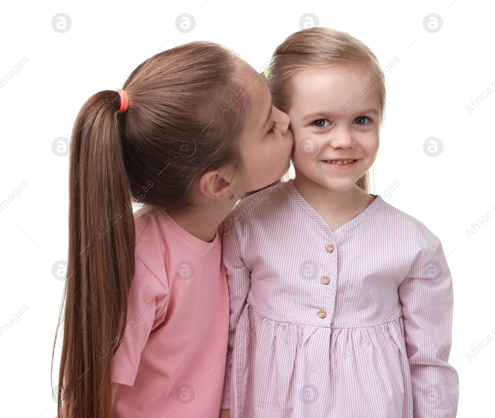 Photo of Portrait of cute little sisters on white background