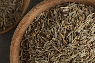Bowl of caraway seeds on table, top view