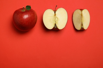 Photo of Flat lay composition with ripe juicy apples on red background, space for text