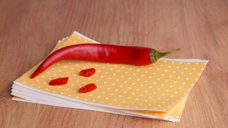 Pepper plasters and chili on wooden table, closeup