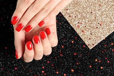 Photo of Woman showing manicured hands with red nail polish on color background, top view. Space for text