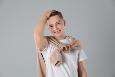 Portrait of teenage boy on light grey background