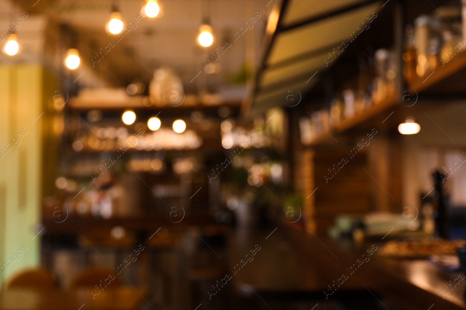 Photo of Blurred view of stylish modern cafe interior with bokeh effect